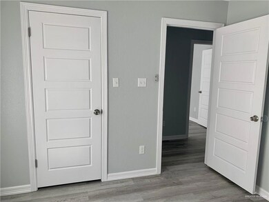 Unfurnished bedroom featuring baseboards and light wood-style flooring