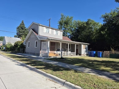 View of front of property with a porch and a front yard