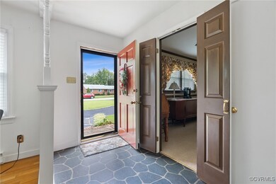 Foyer entrance with dark wood-type flooring and a