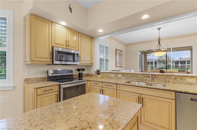 Kitchen with light brown cabinets, sink, stainless