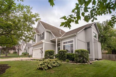 Impeccable landscaping and a grassy front yard wit