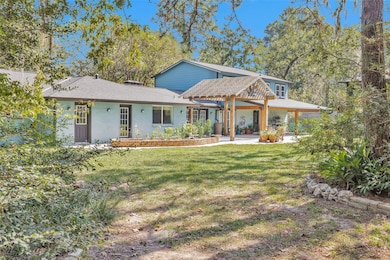 Nestled beneath mature trees, this unique home off