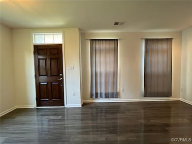 Foyer entrance with baseboards and wood finished f