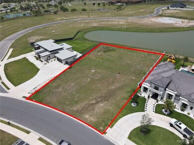 Aerial perspective of suburban area with a large body of water and property parcel outlined
