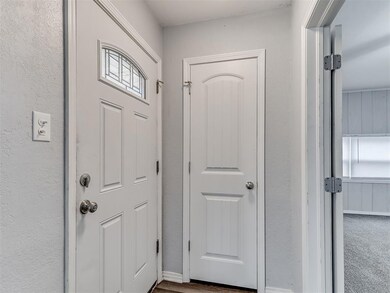 Doorway featuring carpet