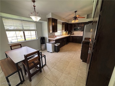 Kitchen with light tile patterned floors, freestan