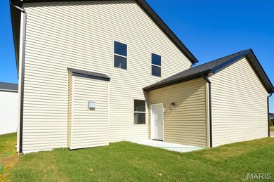 Rear view of house with a lawn and a patio area