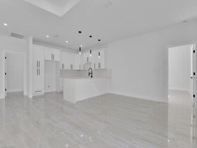 Unfurnished living room featuring sink