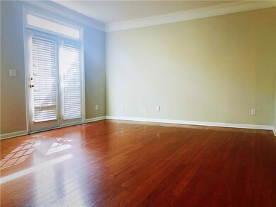 Spare room with dark wood-style floors, ornamental molding, and baseboards