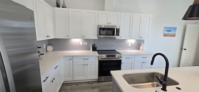 GE appliance package with fridge and glasstop range