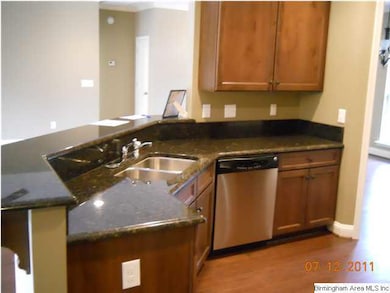 WELL APPOINTED KITCHEN FEATURES HARDWOOD FLOORING.