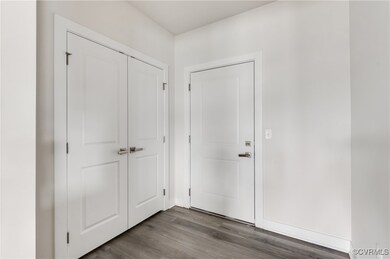 Entrance foyer with dark wood-style floors and bas
