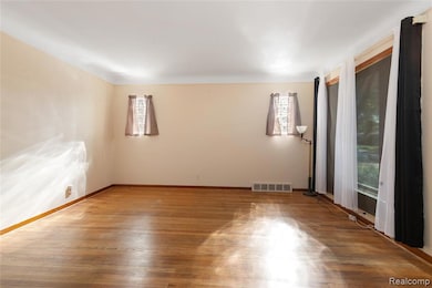 Spare room with wood finished floors