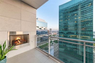 Balcony with a city view and a warm lit fireplace