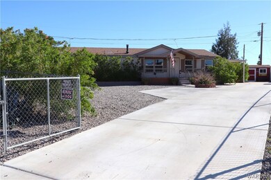 Long concrete driveway with lots of parking and gr