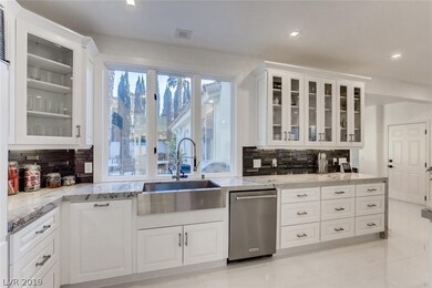 Kitchen with big window looking out to backyard.