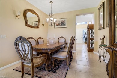 Tiled dining area with a chandelier