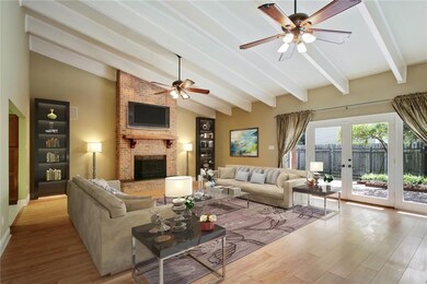 The large den has a gas fireplace, high ceiling an