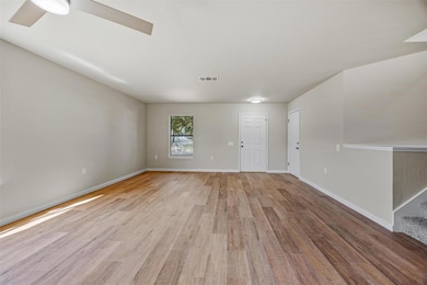 Unfurnished living room featuring light wood fini