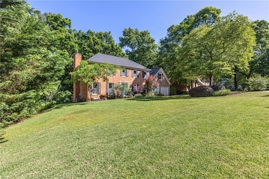 View of front of home featuring a chimney, a front