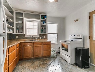 Kitchen featuring brown cabinets, open shelves, wh