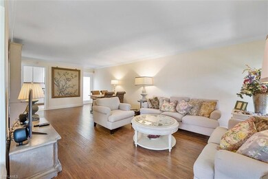 Living room featuring ornamental molding and dark 