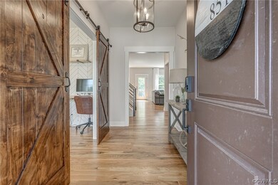 Note the gleaming hardwoods, which run throughout the 1st floor.  These barn doors, leading to the office provide a first glimpse at the character found in this home.