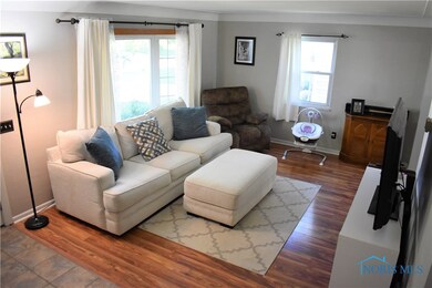 Living Room w/ coved ceiling & bay window.