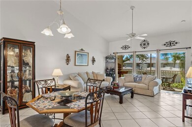 Tiled dining space with lofted ceiling and ceiling