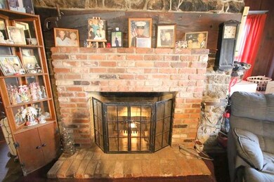 Beautiful Brick Fireplace against Stone Wall (of p