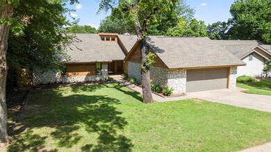 Mid-century inspired home with stone siding, a shingled roof, a front lawn, an attached garage, and driveway