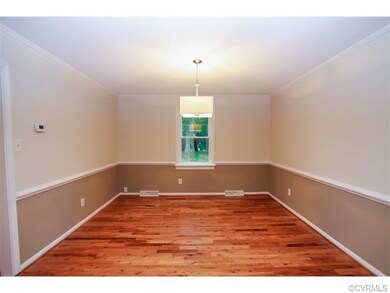 Formal dining room features new hardwood flooring,