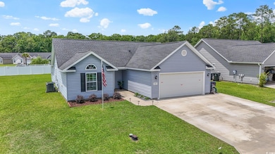 Ranch-style home featuring an attached garage, roof with shingles, driveway, and central AC unit