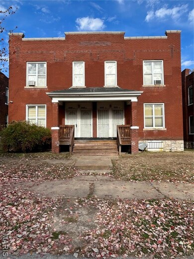 View of front of property featuring brick siding and a porch