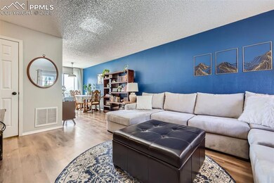 Living room flows into eat-in area next to kitchen