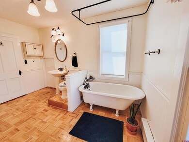 Large bathroom with clawfoot tub.