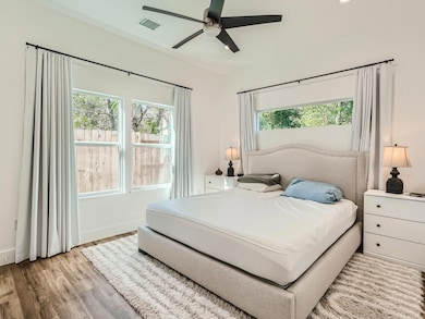 Bedroom featuring wood finished floors, multiple 