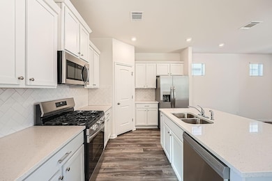Kitchen with stainless steel appliances, dark woo