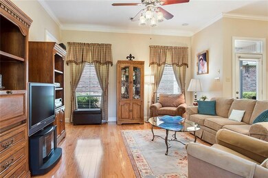 Comfortable den with wood floors, crown molding an
