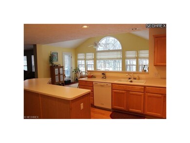 Large, open kitchen with hardwood floors.  Open to