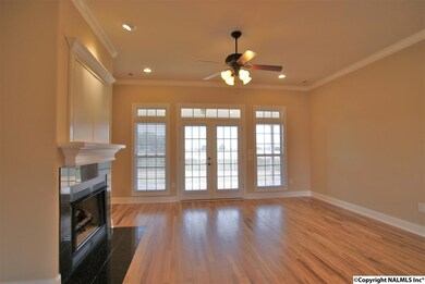 Family room with recessed lighting, fantastic fireplace, hardwood floors, and access to the back porch.