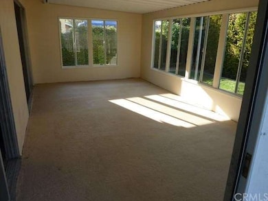 Enclosed patio with sliding windows and screens, a