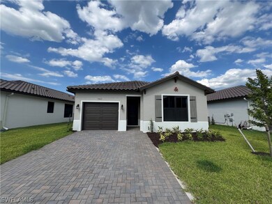View of front of house with a garage and a front y