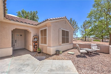Doorway to property with a tile roof, stucco sidin
