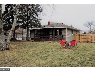 Large fenced backyard with mature trees.