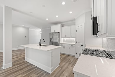 Kitchen featuring stainless steel fridge, white ca
