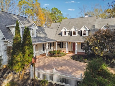 Cape cod-style house featuring a porch