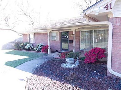 Exterior Front. Flowers in full bloom