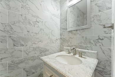 Bathroom with vanity and tile walls