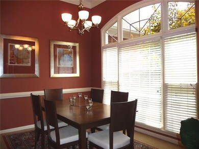 Dining room with plenty of natural light, ornamental molding, and a chandelier